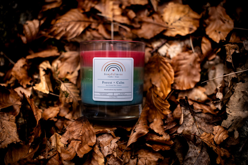 self-care handmade candles on the forest floor