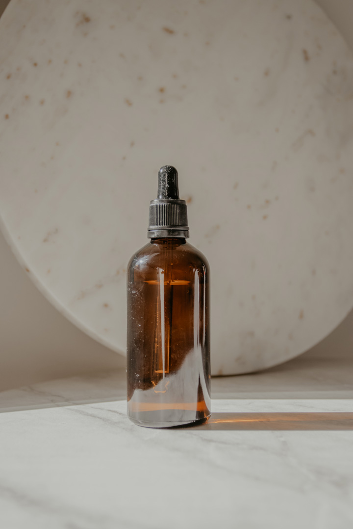How many times can you use Wax Melts? | amber glass essential oil bottle on cream marbled background
