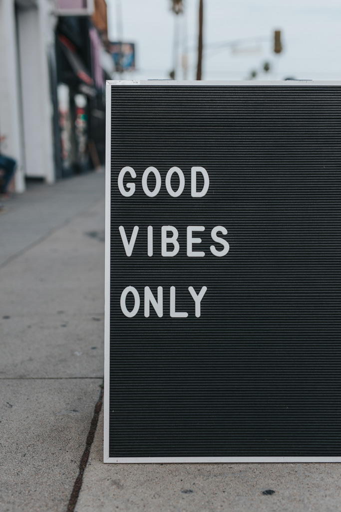 black sign with white writing 'Good Vibes Only'